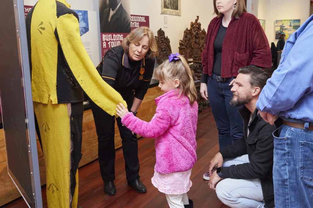 Museum curator shows little girl display