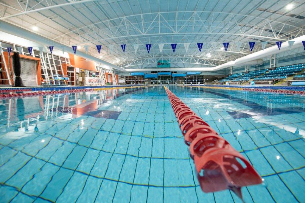 water view of 50m pool with red lane rope and bunting above