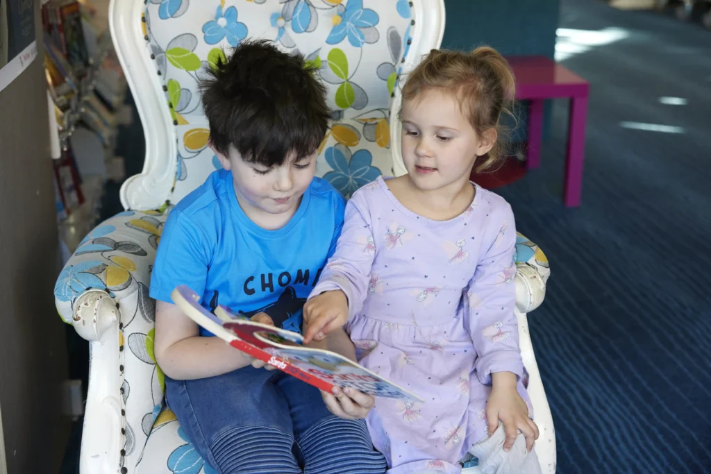 two kids reading book