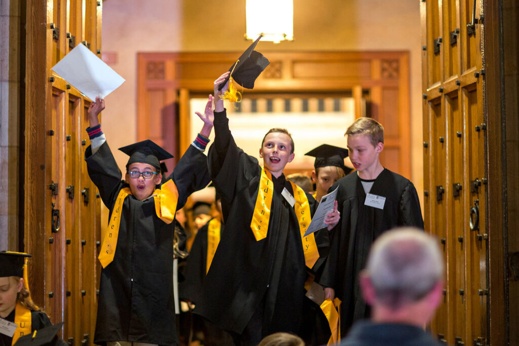 a group of kids in graduation gowns and caps