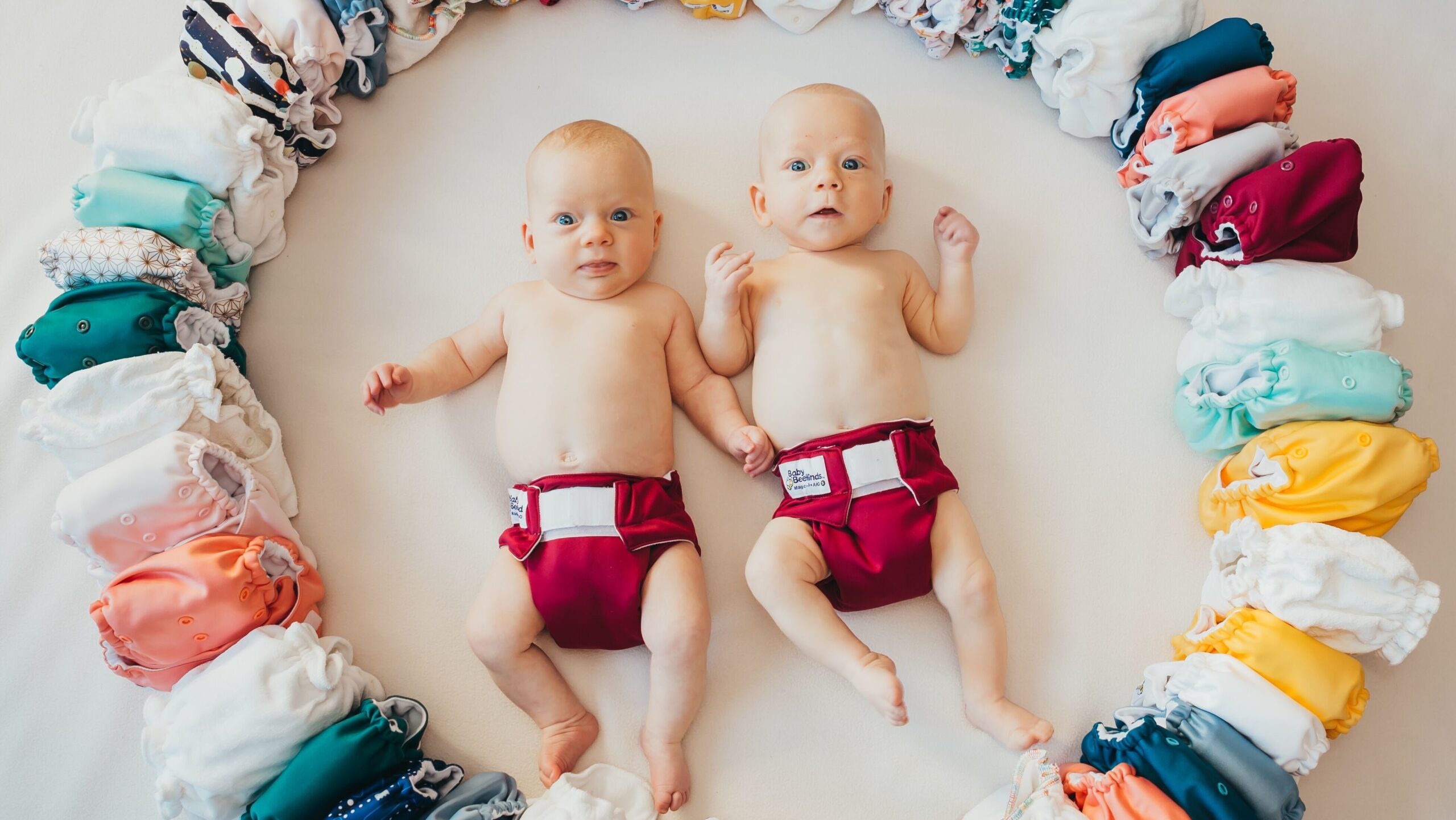 Two babies in reusable nappies.