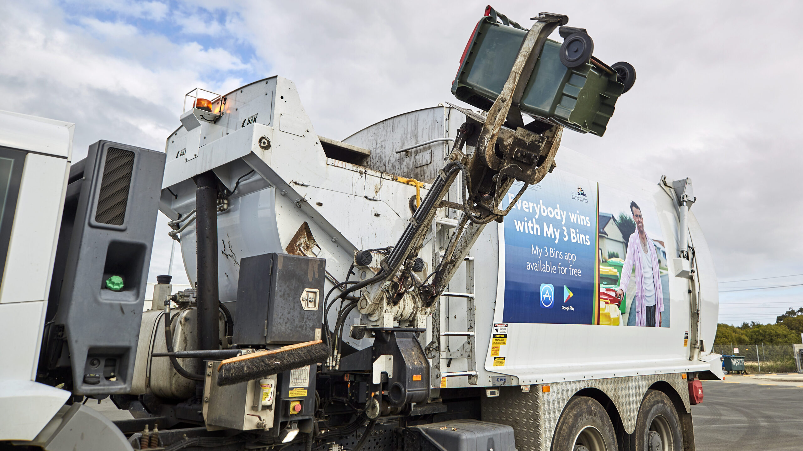 Rubbish truck collecting a bin