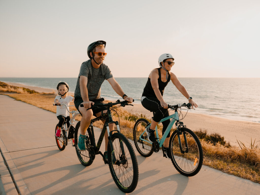 Family riding bikes along Bunbury coastline